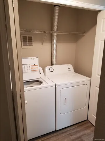 a view of a dinning table and chairs in patio of the house