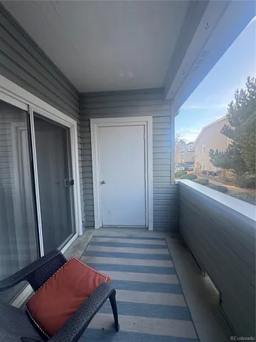 a hallway with sliding door and wooden floor