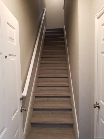 a bathroom with a sink and a chair