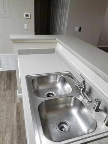 a view of an empty room with wooden floor