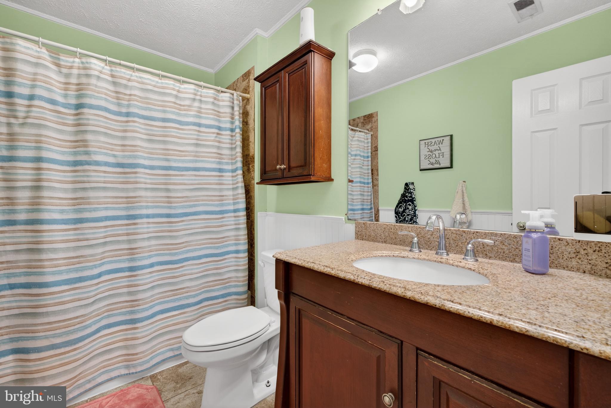 611 Hunting Ridge Drive Frederick, MD 21703 - Photo 33 of 50 a bathroom with a granite countertop toilet sink and mirror