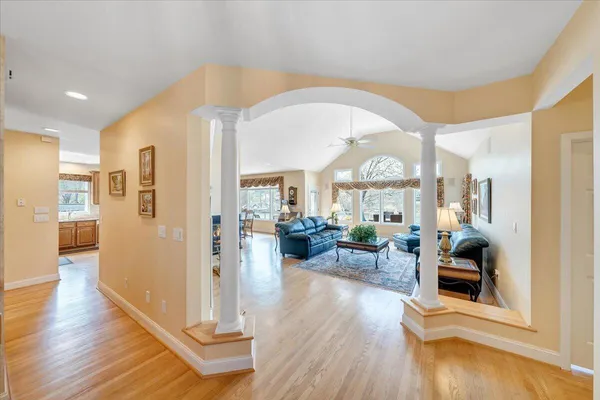 a view of a dining room with furniture a chandelier and wooden floor