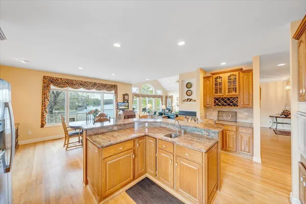 a kitchen with stainless steel appliances granite countertop a refrigerator and a stove top oven
