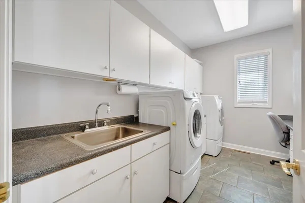 a view of a house with a yard and large tree