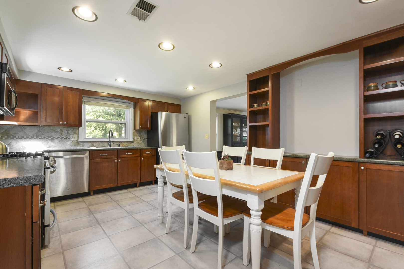 345 Olmsted Road Riverside, IL 60546 - Photo 2 of 31 a large kitchen with a table and chairs