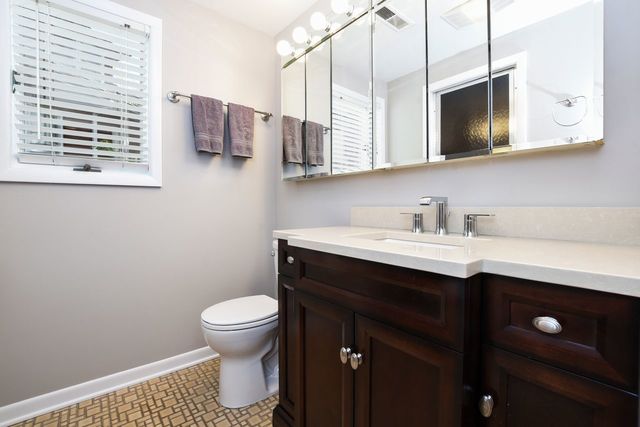 345 Olmsted Road Riverside, IL 60546 - Photo 12 of 31 a bathroom with a sink a toilet and mirror
