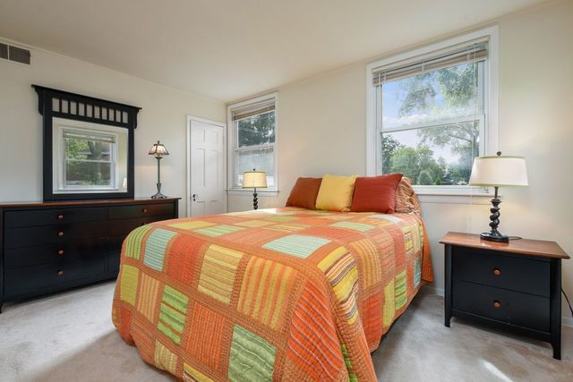345 Olmsted Road Riverside, IL 60546 - Photo 14 of 31 a bedroom with a bed and a window
