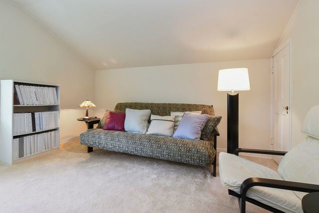 345 Olmsted Road Riverside, IL 60546 - Photo 16 of 31 a living room with a couch and a lamp on table
