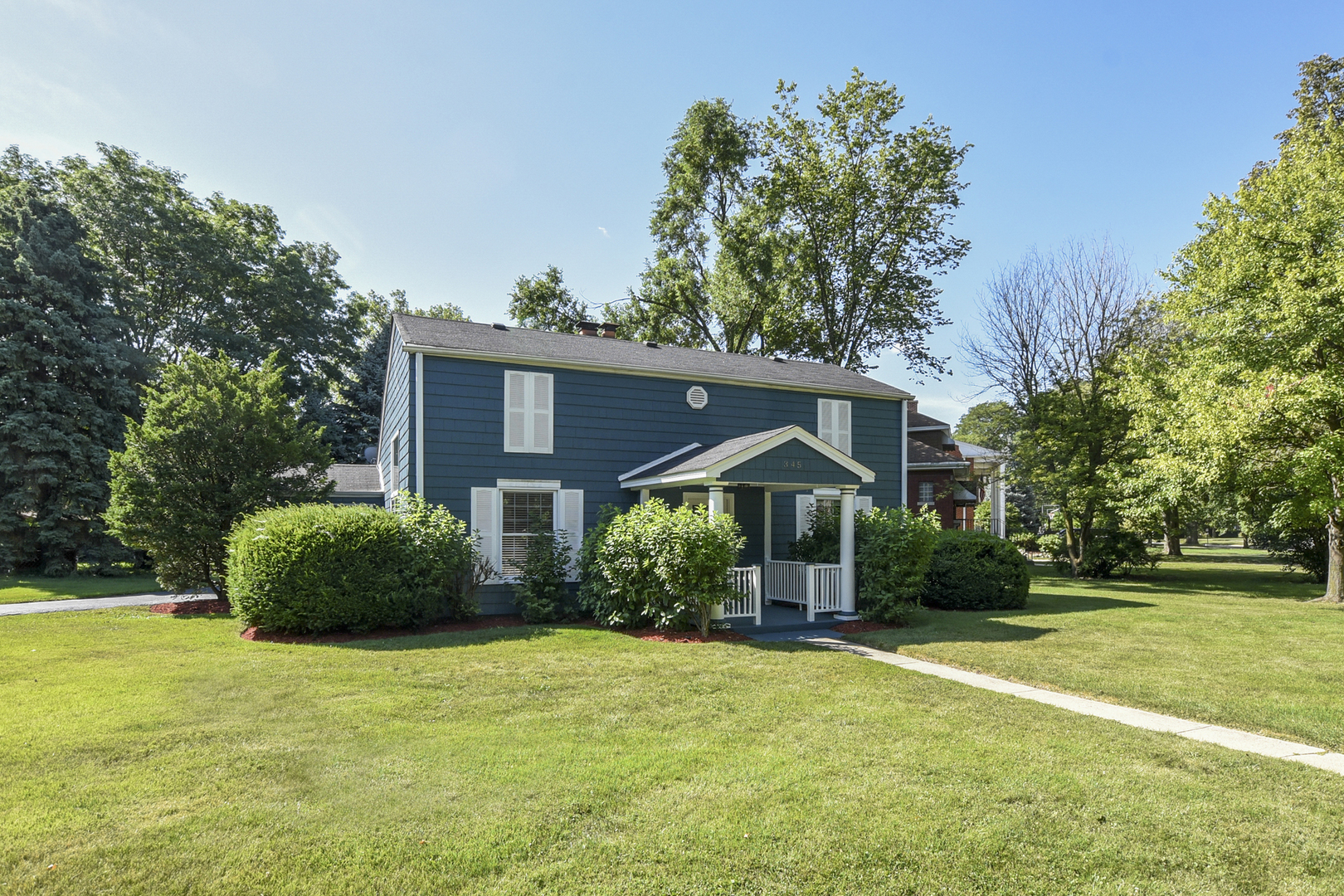 345 Olmsted Road Riverside, IL 60546 - Photo 19 of 31 a front view of a house with a yard