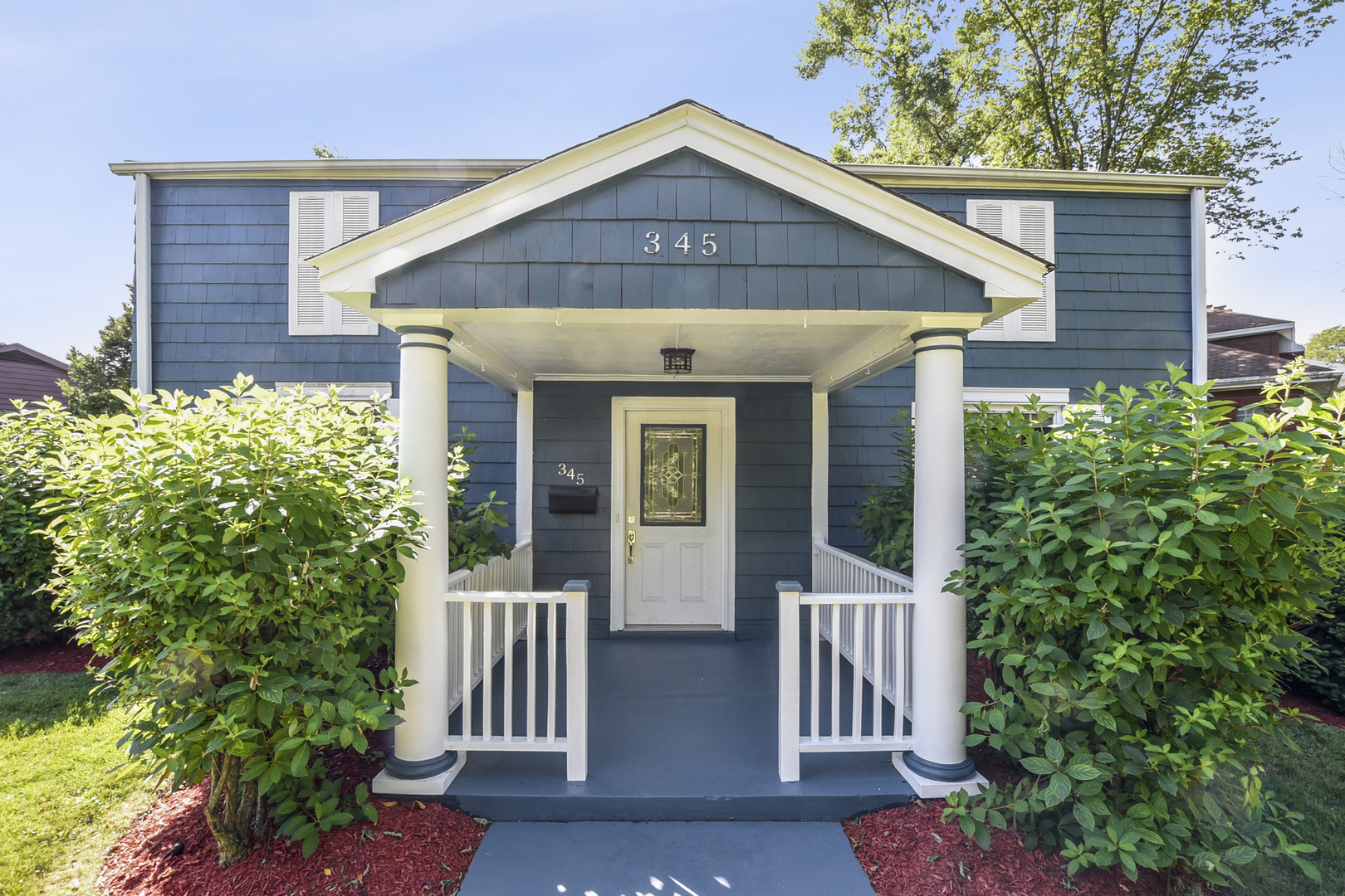 345 Olmsted Road Riverside, IL 60546 - Photo 21 of 31 a front view of a house with garden