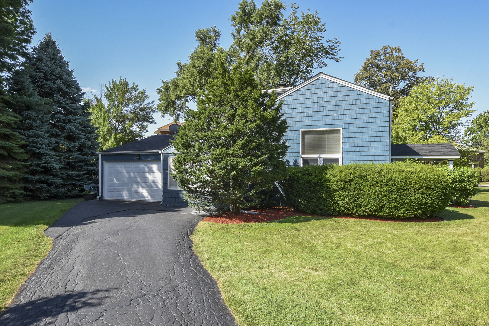 345 Olmsted Road Riverside, IL 60546 - Photo 22 of 31 a front view of a house with a yard and garage