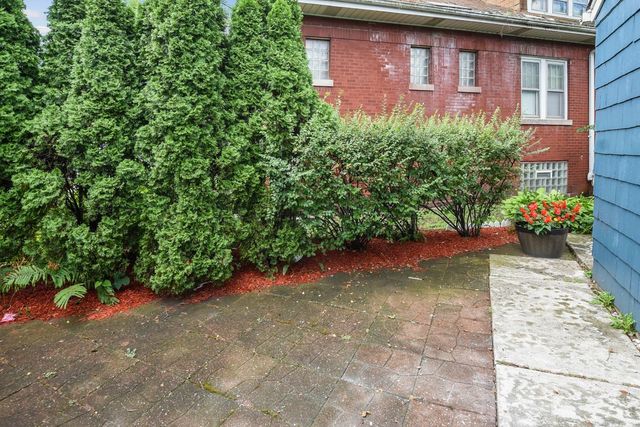 345 Olmsted Road Riverside, IL 60546 - Photo 23 of 31 a view of a brick house with a yard