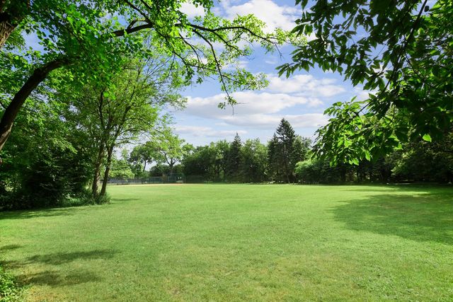345 Olmsted Road Riverside, IL 60546 - Photo 26 of 31 a view of a grassy field with trees in the background