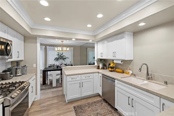a kitchen with a sink stove and microwave
