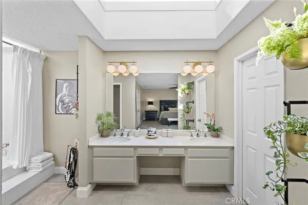 a bathroom with a white bathtub a shower and a sink