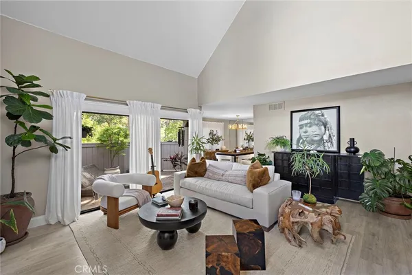 a living room with furniture and a potted plant