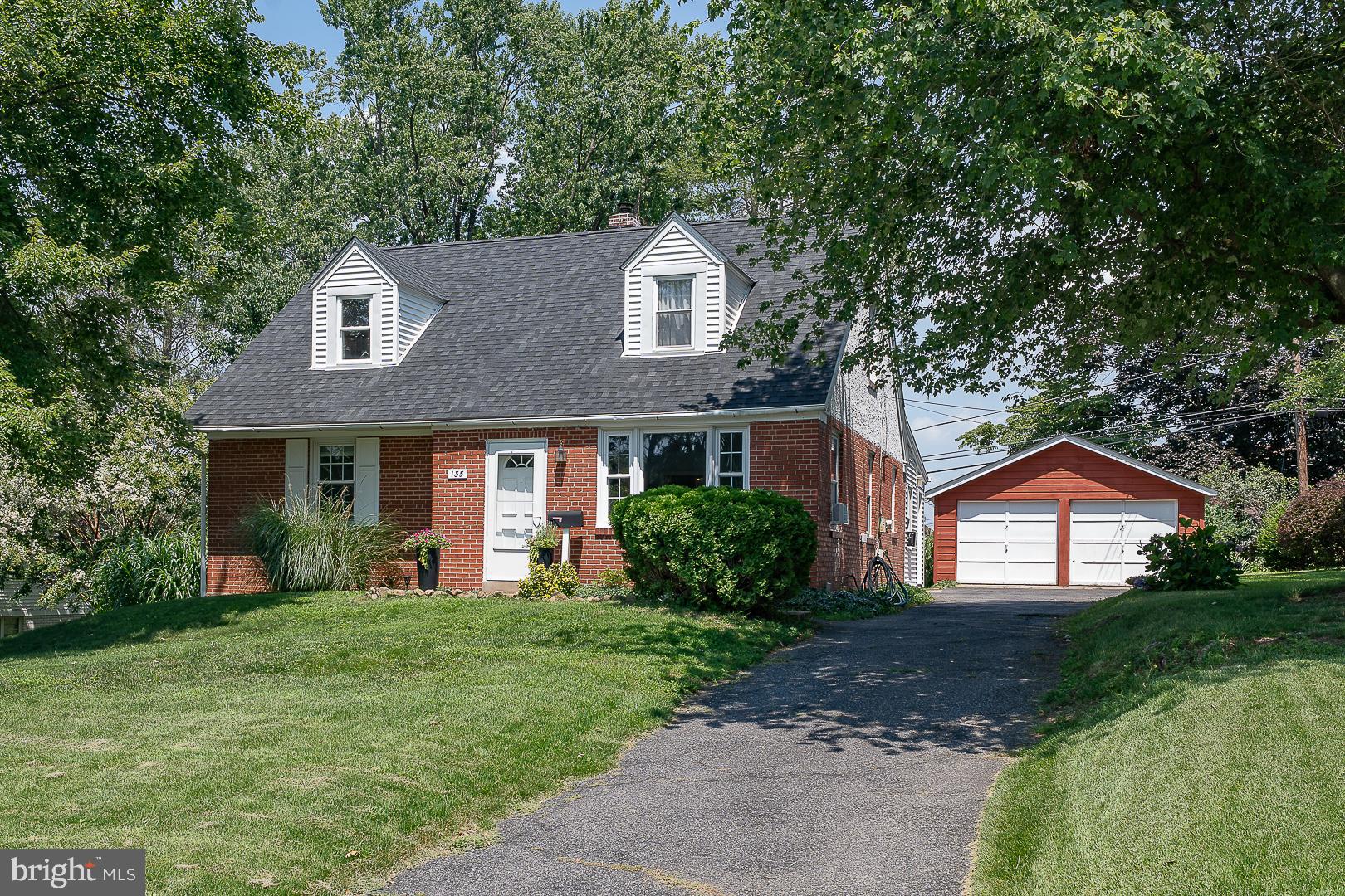 135 Sherman Road Springfield, PA 19064 - Photo 1 of 32 a front view of a house with a yard and garage