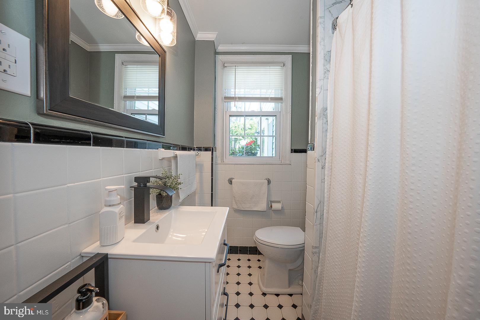 135 Sherman Road Springfield, PA 19064 - Photo 6 of 32 a bathroom with a sink a toilet and a window