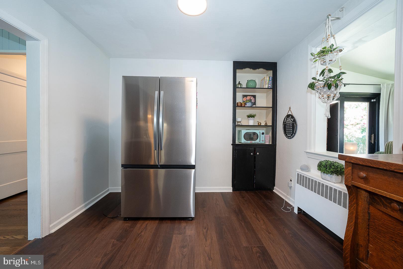 135 Sherman Road Springfield, PA 19064 - Photo 9 of 32 a kitchen with a refrigerator and wooden floor