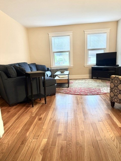 25 Glendower Road, Unit 2 Boston, MA 02131 - Photo 2 of 17 a living room with furniture and a flat screen tv