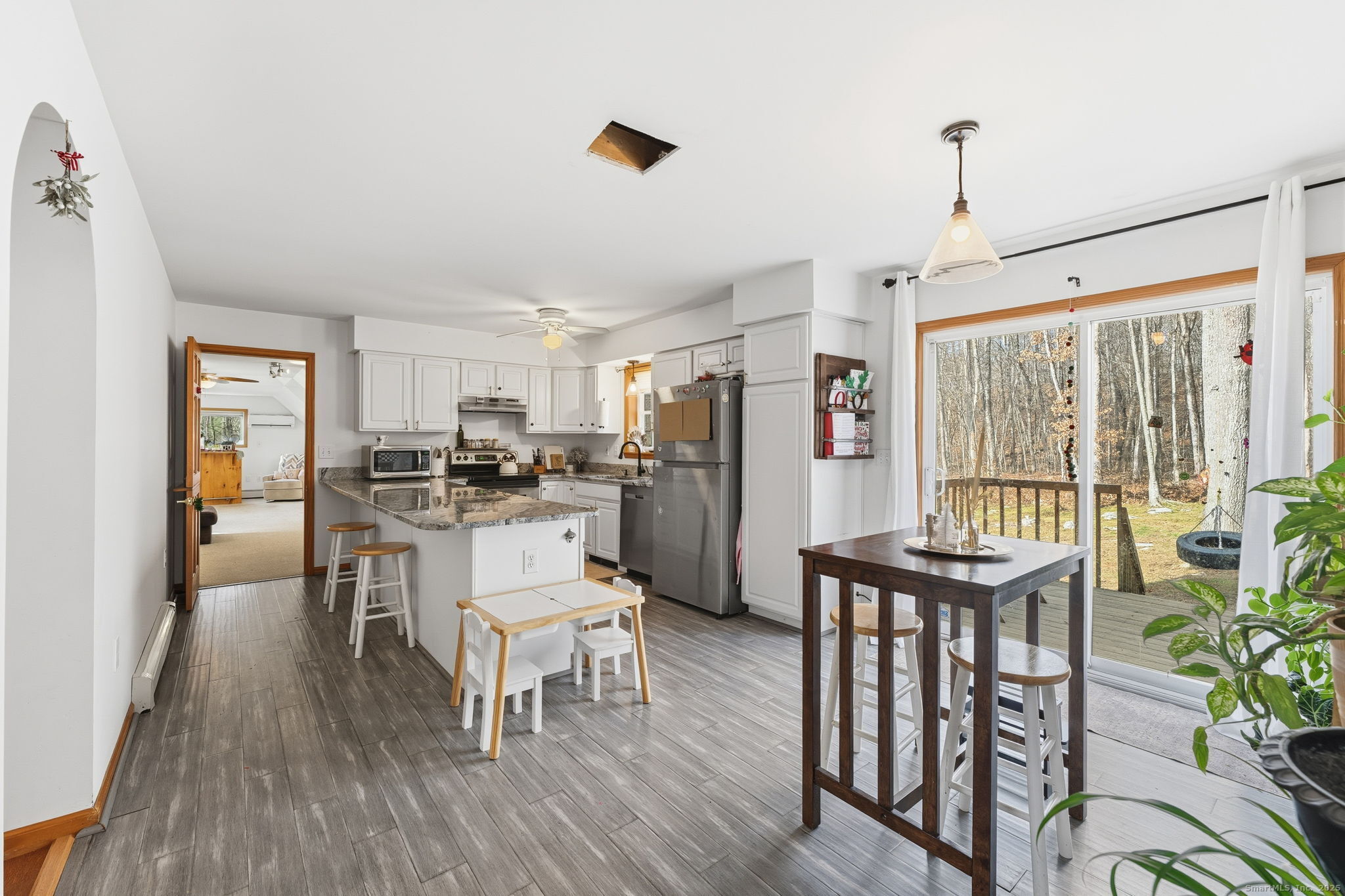87 South Brook Road Hampton, CT 06247 - Photo 13 of 35 a kitchen with a table chairs refrigerator and microwave