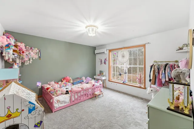 a bedroom with furniture and a chandelier