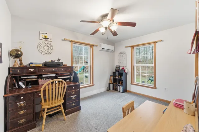 a view of a workspace with furniture and a window