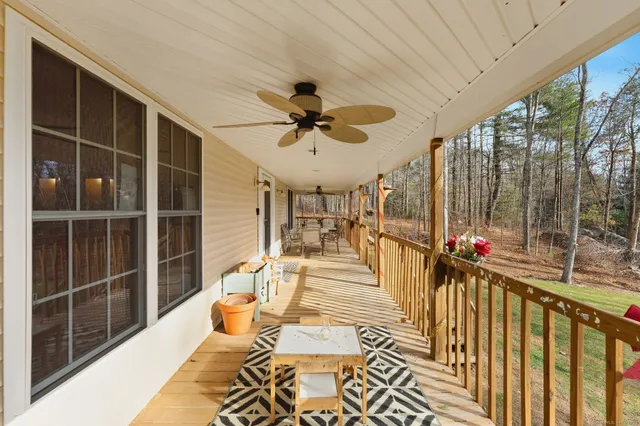a view of a balcony with dining table and chairs with wooden floor