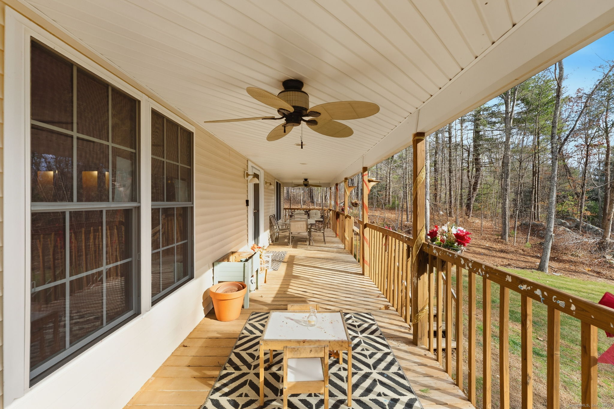 87 South Brook Road Hampton, CT 06247 - Photo 7 of 35 a view of a balcony with dining table and chairs with wooden floor