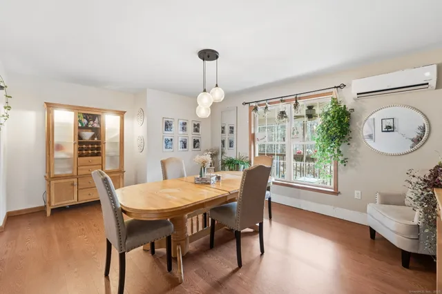 a view of a dining room with furniture window and wooden floor