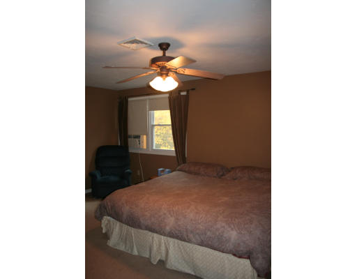 19 Highfield Road, Unit B Charlton, MA 01507 - Photo 17 of 28 a bedroom with a bed and a chandelier