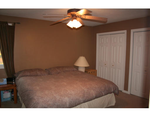 19 Highfield Road, Unit B Charlton, MA 01507 - Photo 18 of 28 a bedroom with a bed and a chandelier