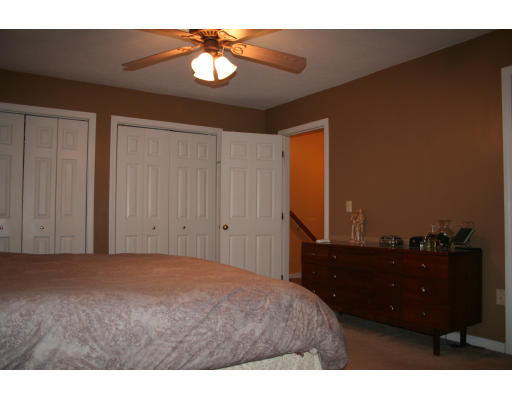 19 Highfield Road, Unit B Charlton, MA 01507 - Photo 19 of 28 a bedroom with a bed and a chandelier