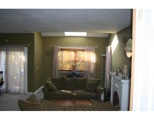 19 Highfield Road, Unit B Charlton, MA 01507 - Photo 21 of 28 a living room with furniture and a chandelier