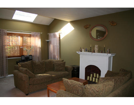 19 Highfield Road, Unit B Charlton, MA 01507 - Photo 3 of 28 a living room with furniture a mirror and a fireplace