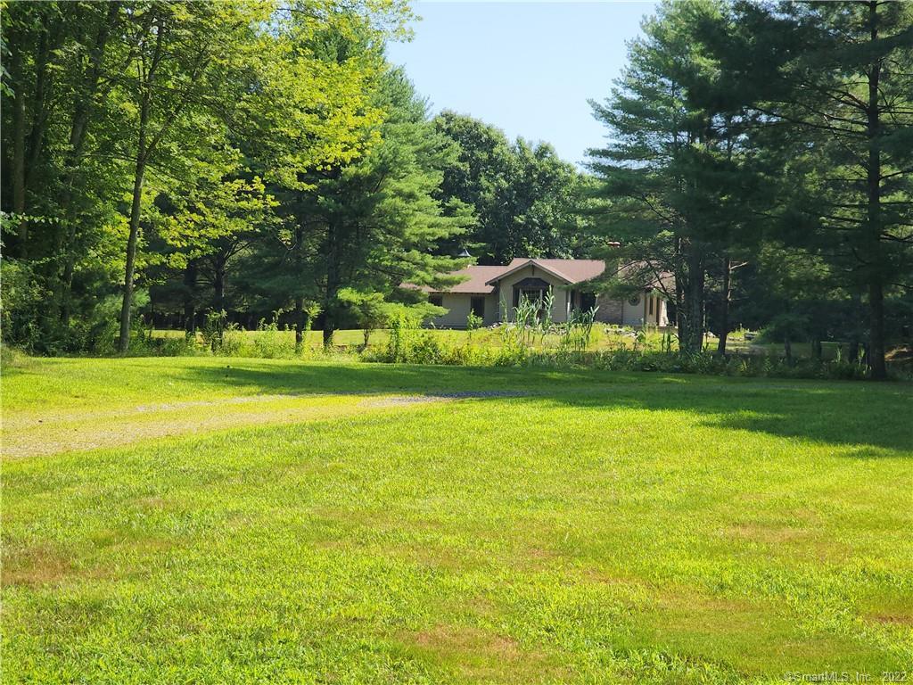 330 Chestnut Hill Road Killingly, CT 06241 - Photo 1 of 1 a view of a swimming pool with lawn chairs and large trees