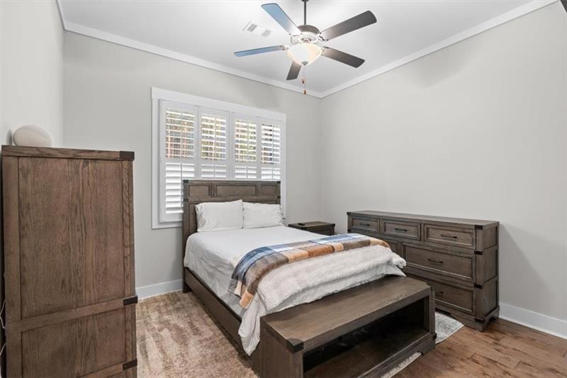283 London Road Ball Ground, GA 30107 - Photo 38 of 73 a bedroom with a bed and a ceiling fan