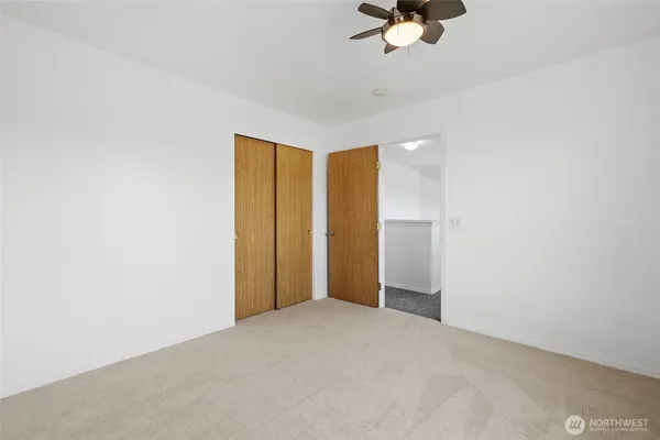 a view of an empty room with a ceiling fan