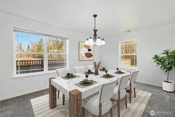 a view of a dining room with furniture window and outside view
