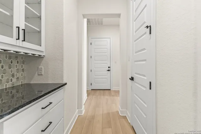 a view of a bathroom with a sink and a granite counter top