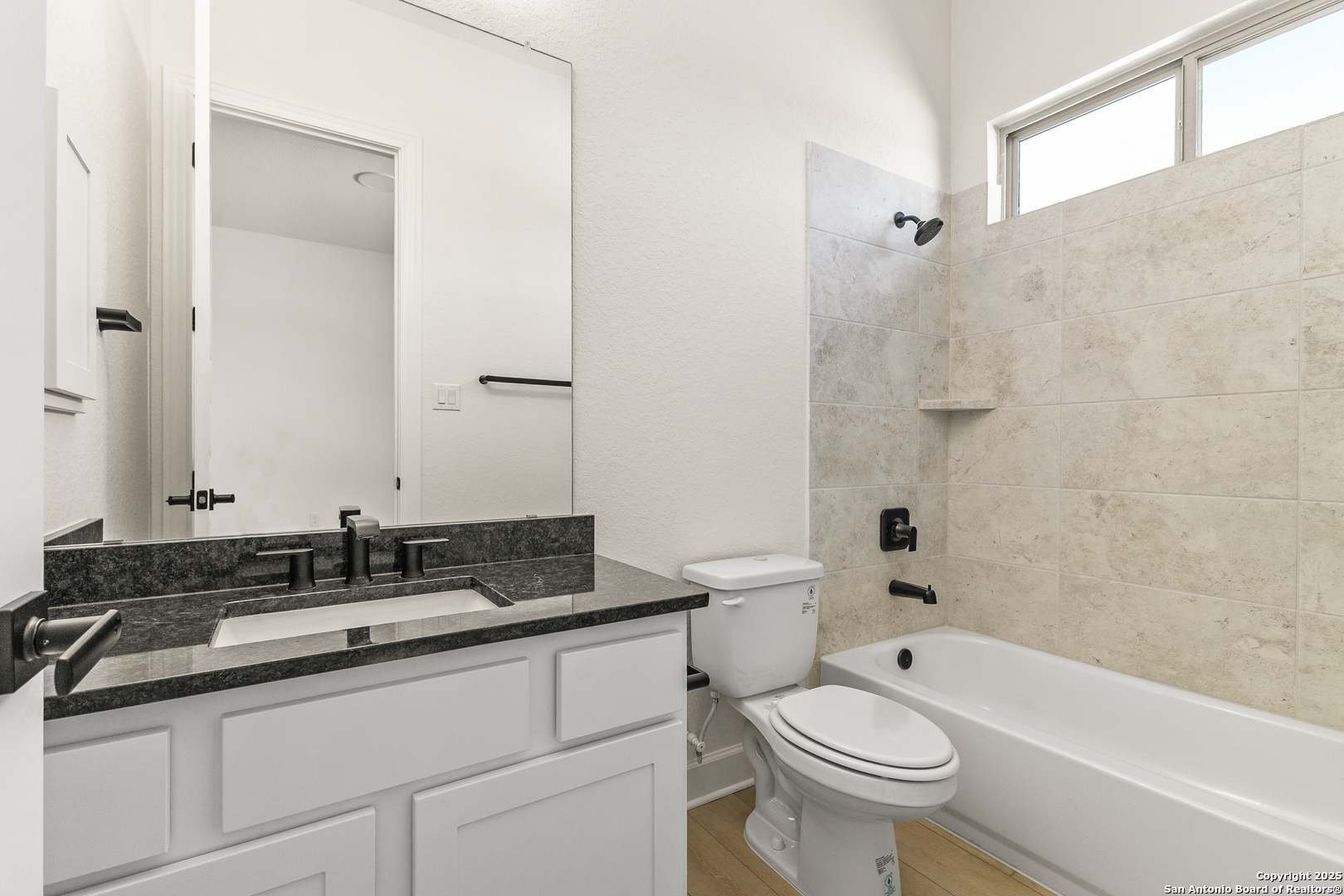 241 Stone Loop Castroville, TX 78009 - Photo 19 of 37 a bathroom with a sink a toilet and a bathtub