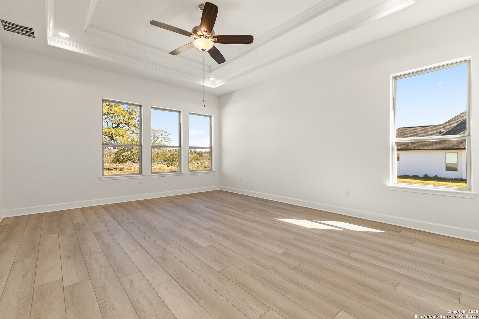 241 Stone Loop Castroville, TX 78009 - Photo 23 of 37 wooden floor in an empty room with a window