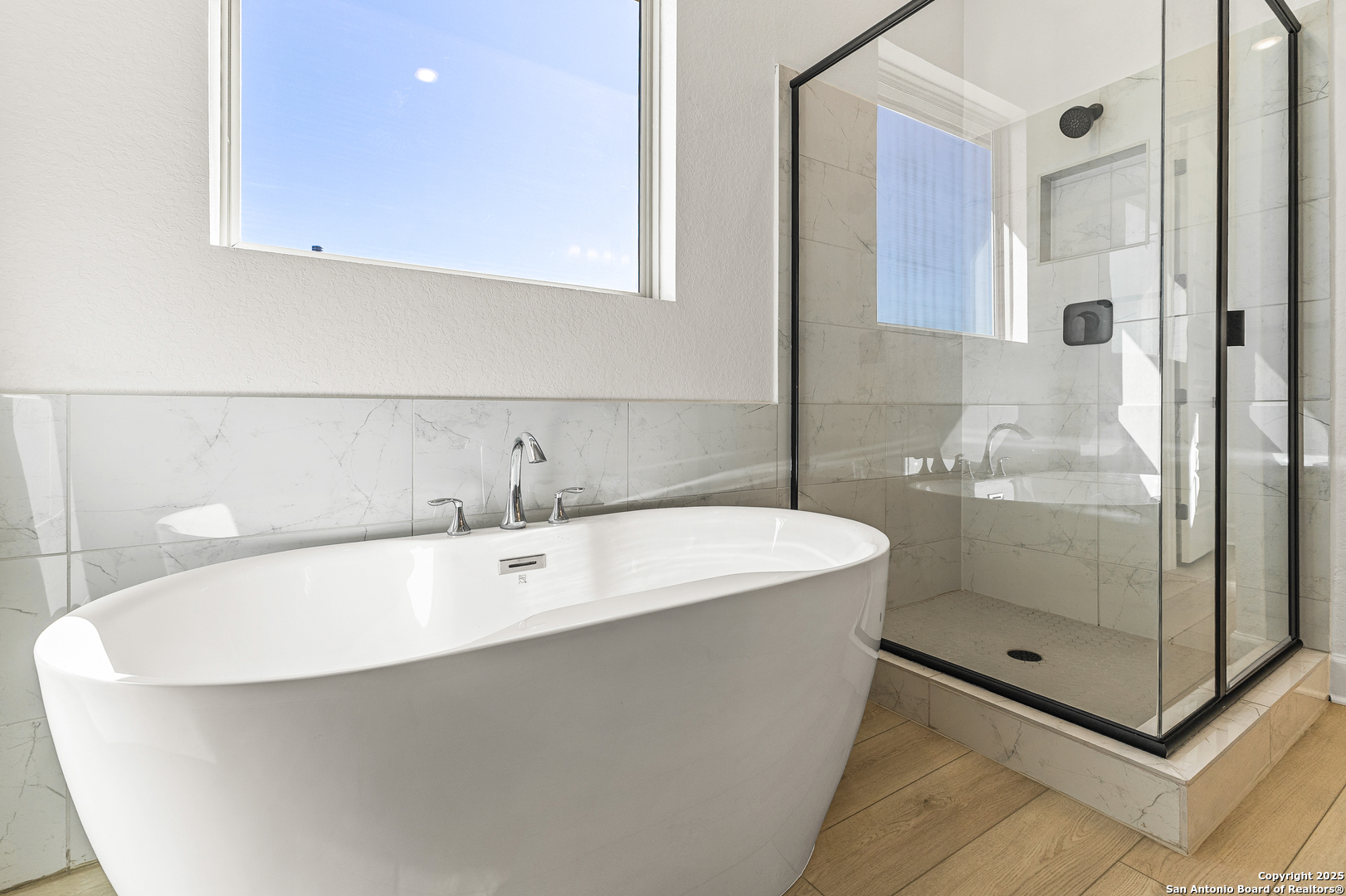 241 Stone Loop Castroville, TX 78009 - Photo 26 of 37 a bathroom with a bathtub and shower