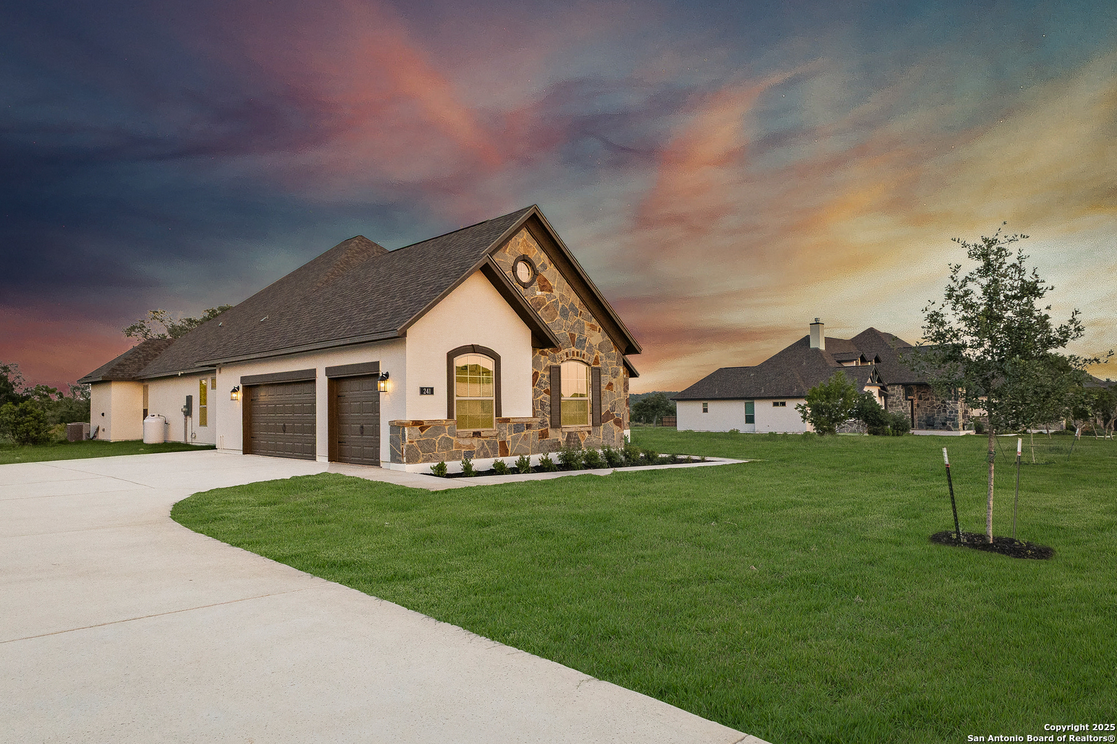 241 Stone Loop Castroville, TX 78009 - Photo 3 of 37 a front view of a house with a yard