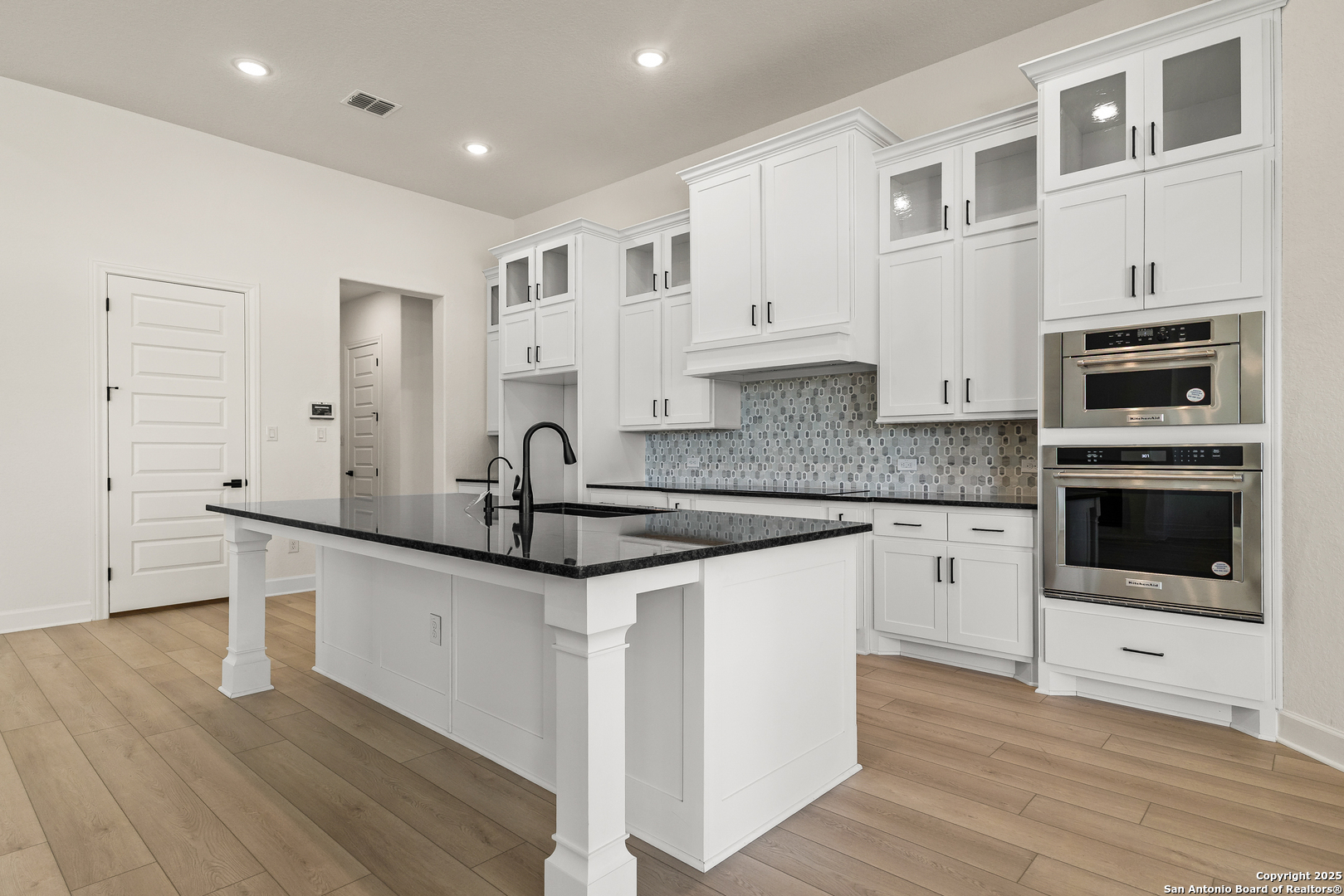 241 Stone Loop Castroville, TX 78009 - Photo 8 of 23 a kitchen with granite countertop a sink and cabinets
