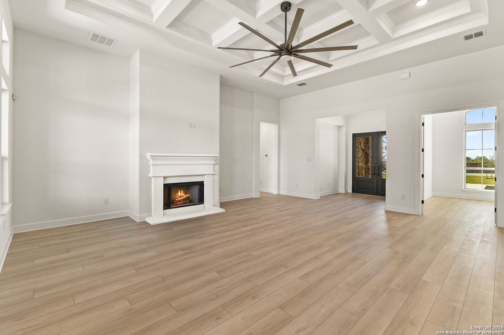 241 Stone Loop Castroville, TX 78009 - Photo 9 of 37 a view of an empty room with wooden floor and a fireplace