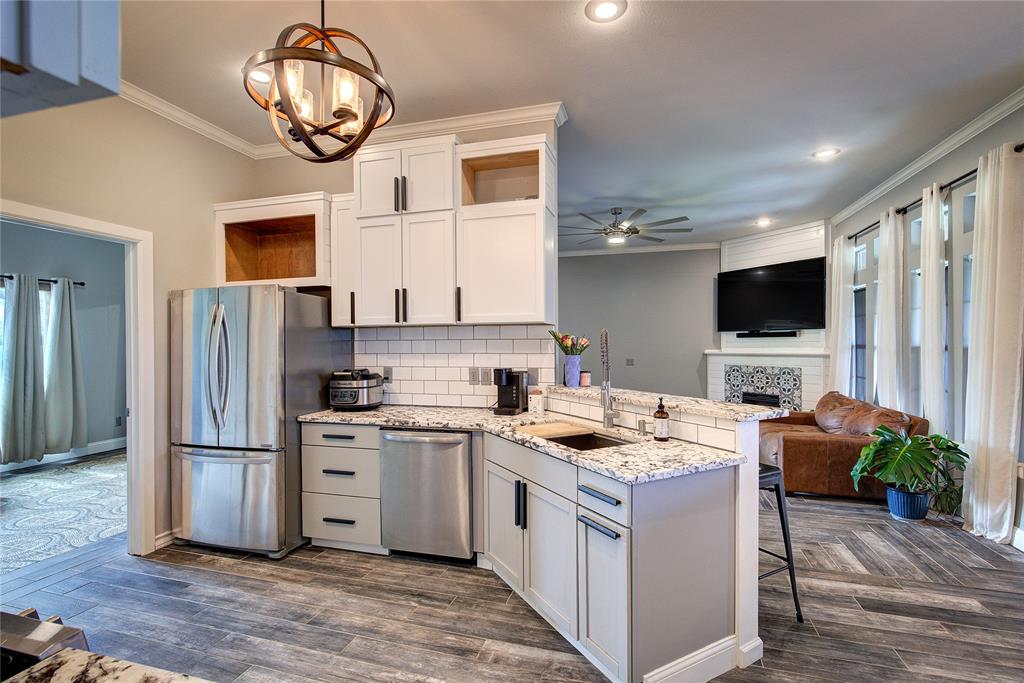 2027 Park Springs Road Sulphur Springs, TX 75482 - Photo 11 of 39 a kitchen with a refrigerator and a stove top oven