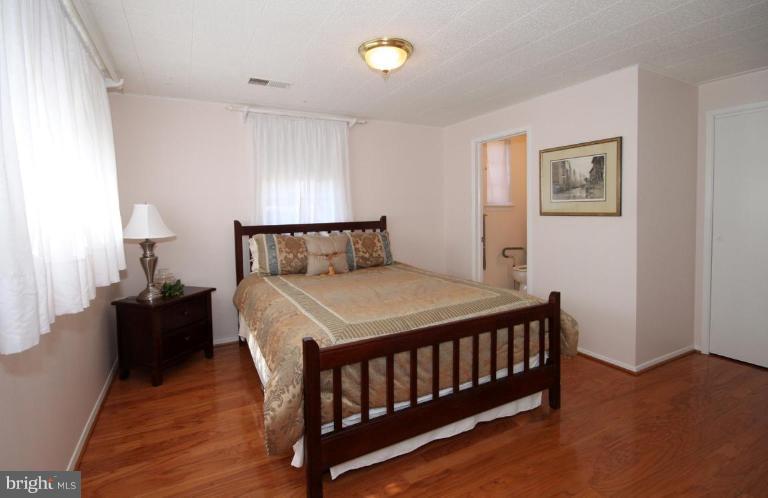 5631 Inverchapel Road Springfield, VA 22151 - Photo 12 of 30 a bedroom with a bed and wooden floor