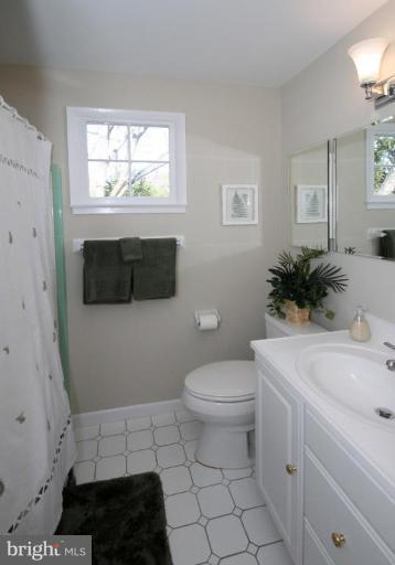 5631 Inverchapel Road Springfield, VA 22151 - Photo 17 of 30 a bathroom with a toilet a sink and a window