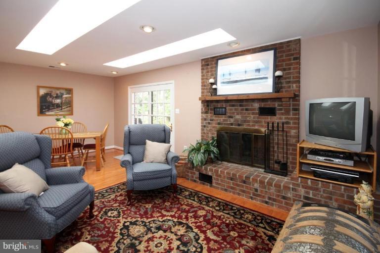 5631 Inverchapel Road Springfield, VA 22151 - Photo 19 of 30 a living room with furniture a flat screen tv and a fireplace